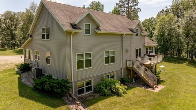 5393 Bachelor Rd NW, Hackensack, MN 56452 - rear view of property featuring a deck, a lawn, stairs, and a shingled roof