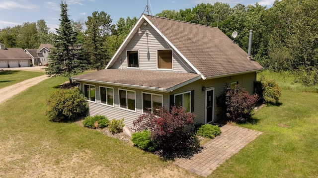 5393 Bachelor Rd NW, Hackensack, MN 56452 - view of front facade with a front lawn, a shingled roof, and a patio