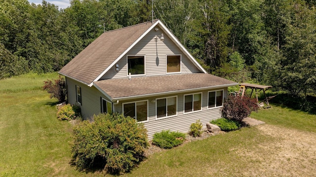 5393 Bachelor Rd NW, Hackensack, MN 56452 - view of front of house with a front lawn, a shingled roof, and a forest view