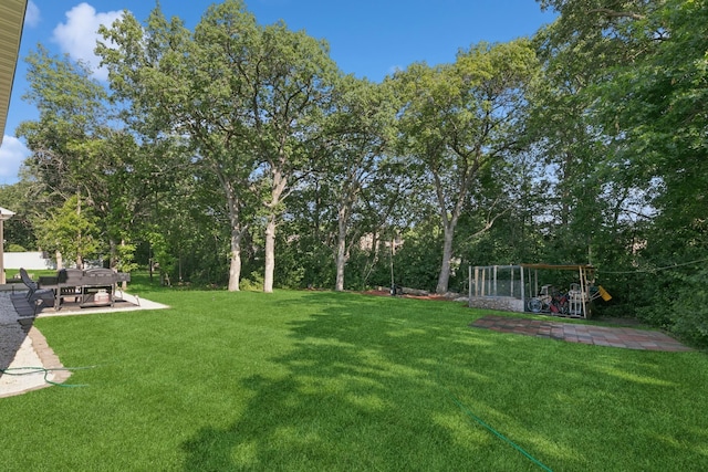1465 19th St SE, Saint Cloud, MN 56304 - view of grassy yard with a patio, a playground, and view of scattered trees