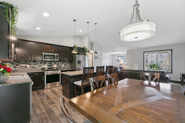 1465 19th St SE, Saint Cloud, MN 56304 - dining room featuring vaulted ceiling, dark wood-type flooring, recessed lighting, and a chandelier