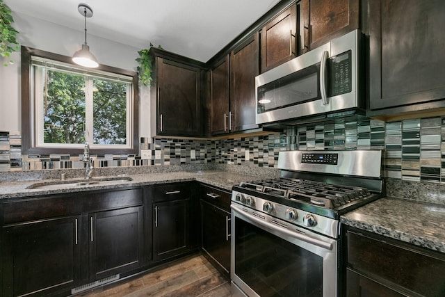 1465 19th St SE, Saint Cloud, MN 56304 - kitchen featuring appliances with stainless steel finishes, dark stone countertops, backsplash, and dark wood-type flooring