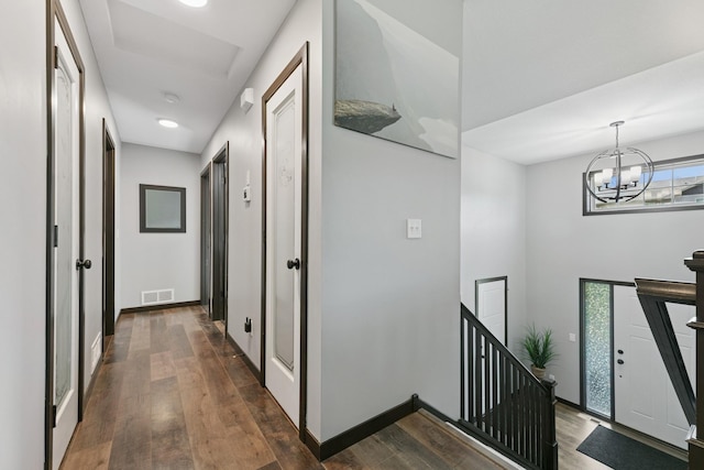 1465 19th St SE, Saint Cloud, MN 56304 - hallway with an upstairs landing, dark wood-type flooring, and a chandelier