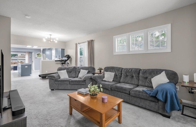 402 Clifton St, Saint Paul, MN 55102 - carpeted living area with a chandelier, plenty of natural light, and a textured ceiling