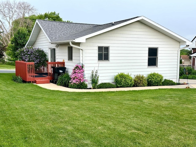 607 Washington Ave, Spring Valley, MN 55975 - view of side of home featuring a shingled roof and a lawn