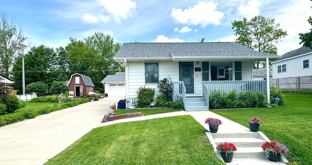 607 Washington Ave, Spring Valley, MN 55975 - bungalow with covered porch, a detached garage, and a shingled roof