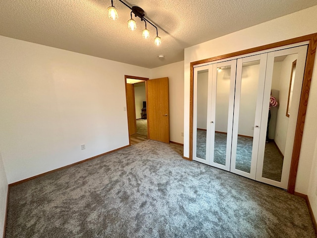 607 Washington Ave, Spring Valley, MN 55975 - unfurnished bedroom with a textured ceiling, carpet, and a closet