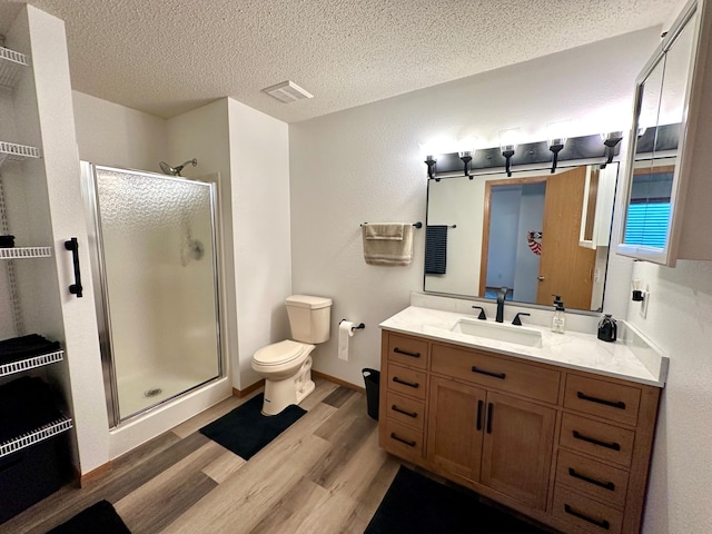 607 Washington Ave, Spring Valley, MN 55975 - bathroom with a shower stall, wood finished floors, vanity, and a textured ceiling