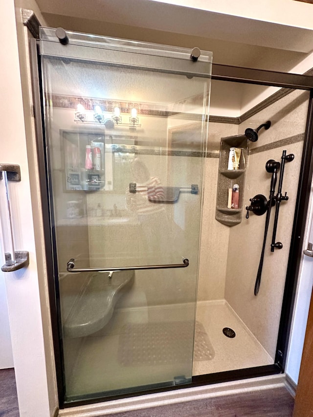 607 Washington Ave, Spring Valley, MN 55975 - full bathroom featuring a shower stall and wood finished floors