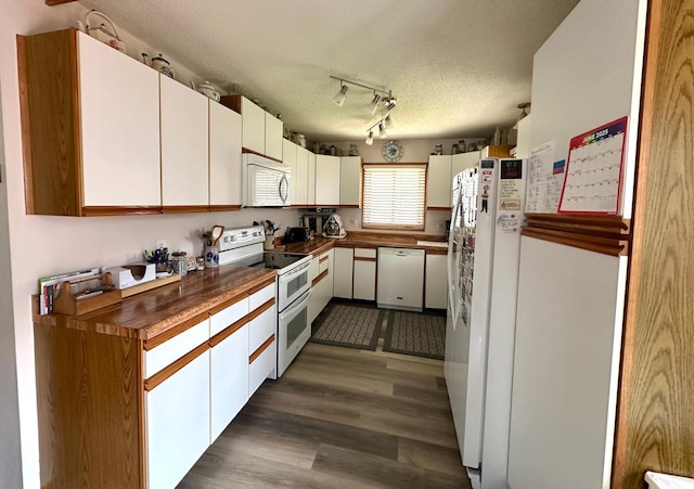 607 Washington Ave, Spring Valley, MN 55975 - kitchen featuring white appliances, dark wood-type flooring, a textured ceiling, white cabinetry, and track lighting