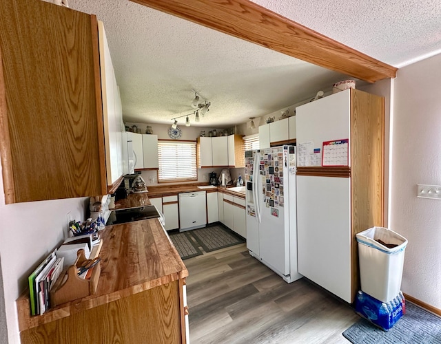 607 Washington Ave, Spring Valley, MN 55975 - kitchen with white appliances, a textured ceiling, wood counters, dark wood-type flooring, and white cabinets