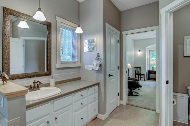 1403 Elm Ave W, Menomonie, WI 54751 - bathroom featuring plenty of natural light, vanity, and backsplash