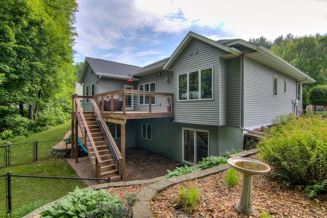 1403 Elm Ave W, Menomonie, WI 54751 - back of property with a gate, a wooden deck, stairway, and a patio area