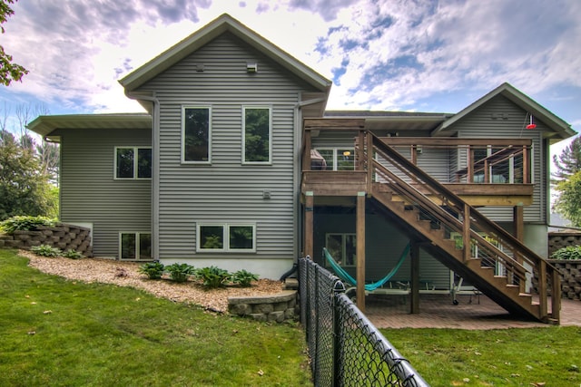 1403 Elm Ave W, Menomonie, WI 54751 - rear view of property featuring a fenced backyard, a deck, and stairway