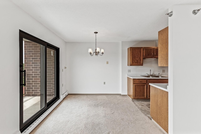 6615 Lake Shore Dr S Unit 900, Richfield, MN 55423 - kitchen featuring light carpet, light countertops, brown cabinetry, a chandelier, and hanging light fixtures