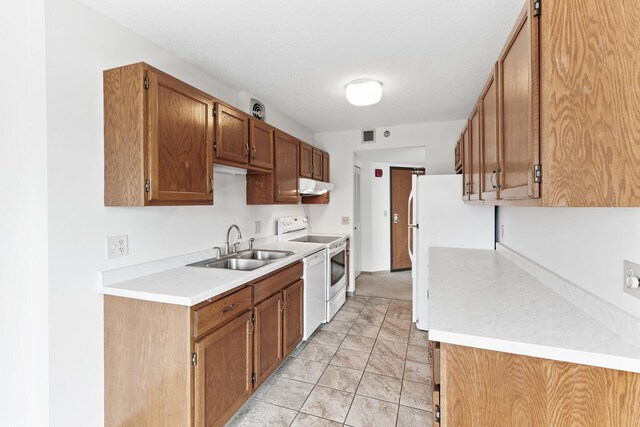 6615 Lake Shore Dr S Unit 900, Richfield, MN 55423 - kitchen featuring white appliances, under cabinet range hood, light countertops, and brown cabinetry