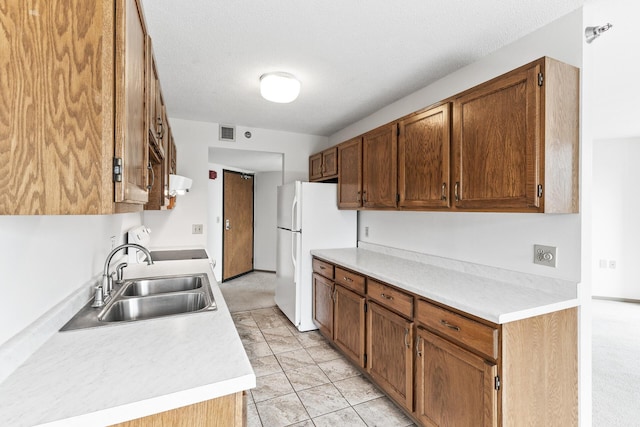 6615 Lake Shore Dr S Unit 900, Richfield, MN 55423 - kitchen featuring freestanding refrigerator, light countertops, extractor fan, range, and brown cabinets