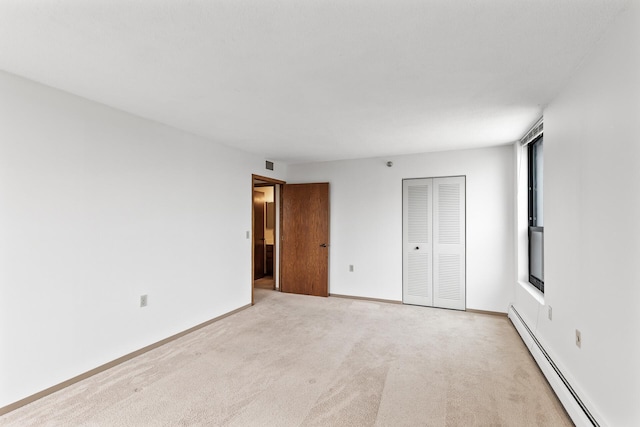 6615 Lake Shore Dr S Unit 900, Richfield, MN 55423 - unfurnished bedroom featuring a baseboard heating unit, a closet, and light colored carpet
