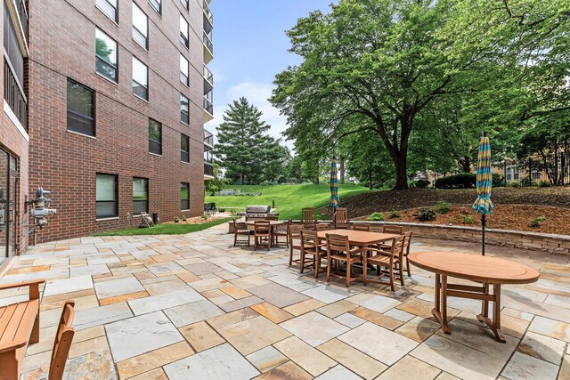 6615 Lake Shore Dr S Unit 900, Richfield, MN 55423 - view of patio featuring outdoor dining area and a grill
