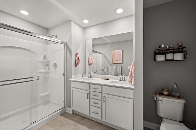 1771 Emerson Ct, Chaska, MN 55318 - bathroom with a shower stall, double vanity, and recessed lighting