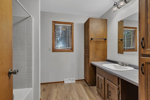 920 2nd Ave S, Sauk Rapids, MN 56379 - bathroom featuring vanity, wood finished floors, and bathing tub / shower combination