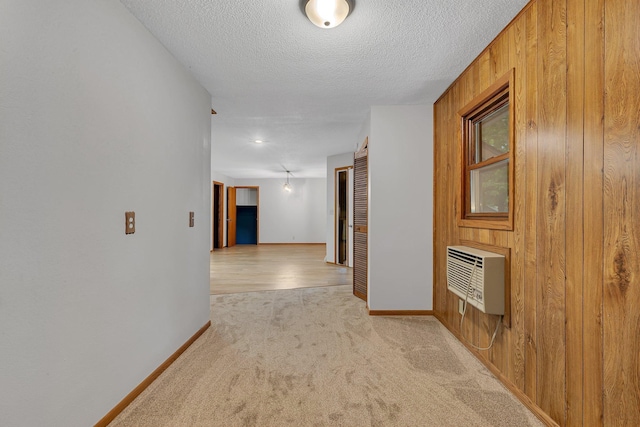 920 2nd Ave S, Sauk Rapids, MN 56379 - corridor featuring light carpet, wood walls, and a textured ceiling