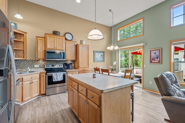 3123 Legacy Ln, Woodbury, MN 55129 - kitchen featuring stainless steel appliances, a breakfast bar, open floor plan, light countertops, and a center island