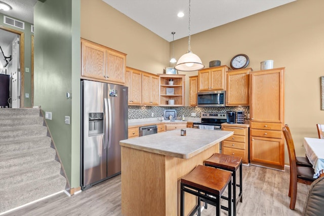 3123 Legacy Ln, Woodbury, MN 55129 - kitchen featuring stainless steel appliances, light wood finished floors, open shelves, a towering ceiling, and light countertops