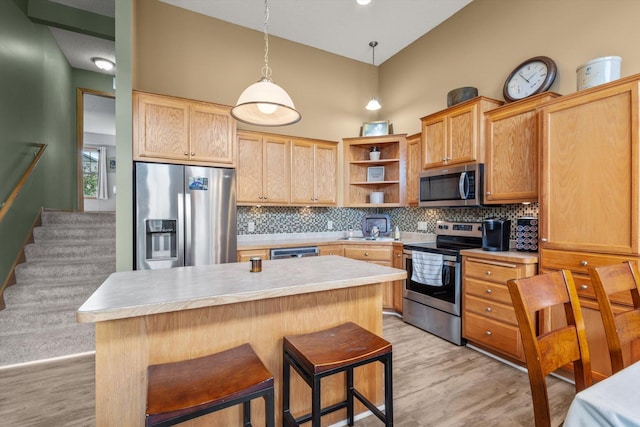 3123 Legacy Ln, Woodbury, MN 55129 - kitchen with stainless steel appliances, open shelves, light countertops, decorative backsplash, and light wood-type flooring