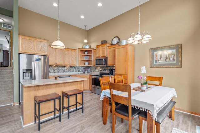 3123 Legacy Ln, Woodbury, MN 55129 - kitchen with appliances with stainless steel finishes, light brown cabinets, open shelves, a high ceiling, and a kitchen island