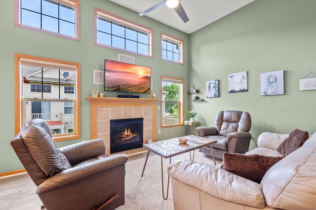 3123 Legacy Ln, Woodbury, MN 55129 - living area with a high ceiling, ceiling fan, a tiled fireplace, and wood finished floors