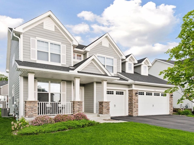 7154 Alphabet St, Chanhassen, MN 55317 - view of front facade with stone siding, covered porch, asphalt driveway, and a front yard