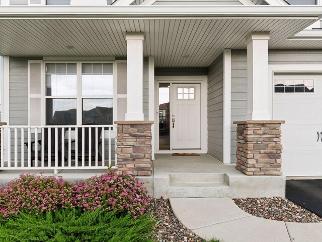 7154 Alphabet St, Chanhassen, MN 55317 - doorway to property featuring covered porch and stone siding