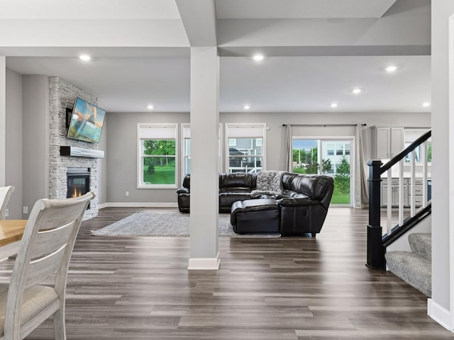 7154 Alphabet St, Chanhassen, MN 55317 - living area featuring a stone fireplace, stairs, recessed lighting, and dark wood finished floors