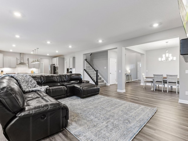 7154 Alphabet St, Chanhassen, MN 55317 - living room featuring recessed lighting, light wood-style floors, stairway, and a chandelier