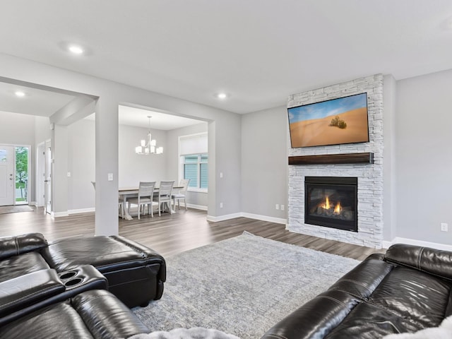 7154 Alphabet St, Chanhassen, MN 55317 - living area with wood finished floors, a chandelier, a stone fireplace, and recessed lighting