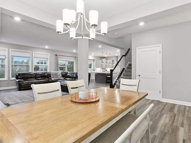 7154 Alphabet St, Chanhassen, MN 55317 - dining room featuring wood finished floors, a chandelier, stairway, and recessed lighting
