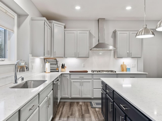 7154 Alphabet St, Chanhassen, MN 55317 - kitchen with wall chimney exhaust hood, dark wood finished floors, decorative light fixtures, tasteful backsplash, and stainless steel appliances
