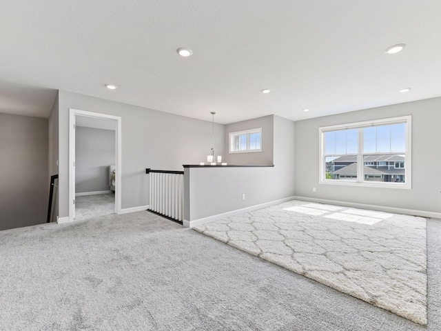 7154 Alphabet St, Chanhassen, MN 55317 - carpeted spare room with a chandelier and recessed lighting