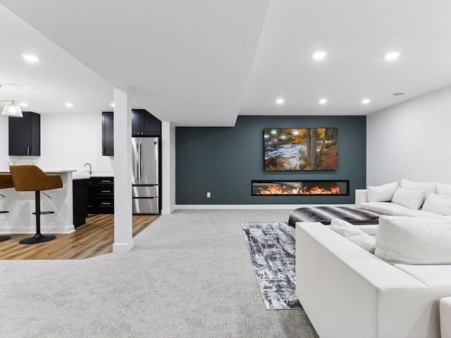 7154 Alphabet St, Chanhassen, MN 55317 - living area featuring recessed lighting, light carpet, a glass covered fireplace, and wet bar