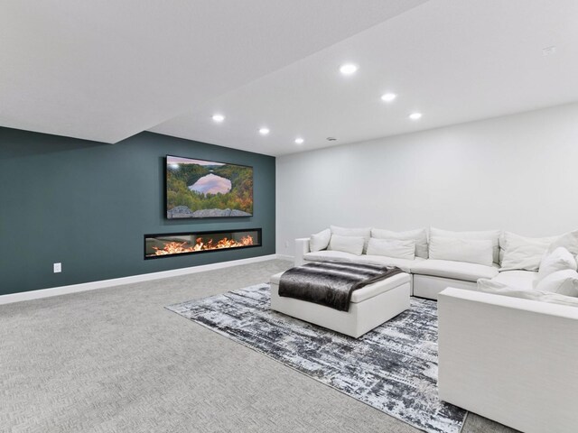 7154 Alphabet St, Chanhassen, MN 55317 - living room featuring recessed lighting, a glass covered fireplace, and carpet flooring