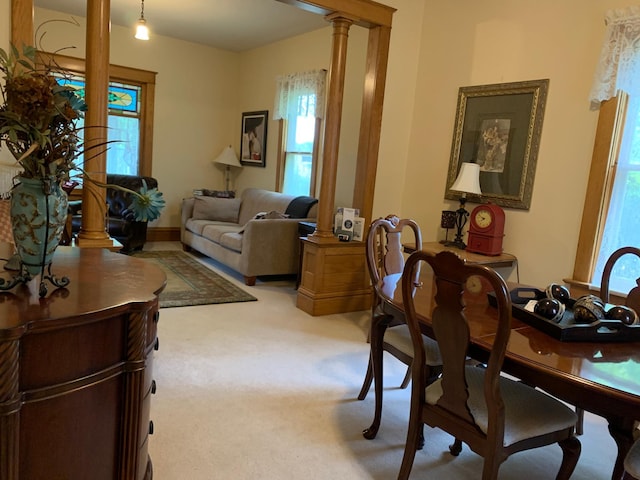 821 3rd Ave, Madison, MN 56256 - dining room featuring decorative columns, plenty of natural light, and light colored carpet