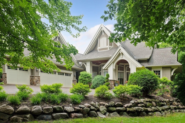 1904 Linner Rd, Minnetonka, MN 55391 - view of front of home with stone siding, roof with shingles, and driveway