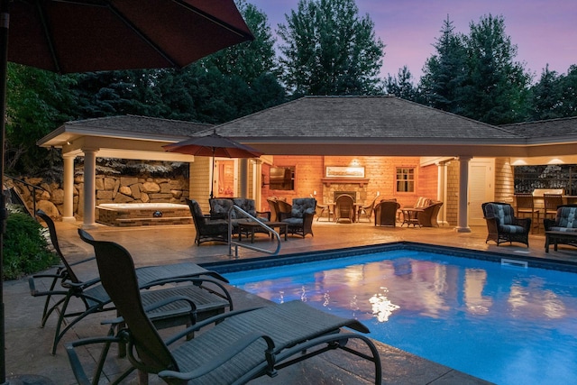 1904 Linner Rd, Minnetonka, MN 55391 - pool at dusk featuring a storage structure, an outbuilding, and a patio area