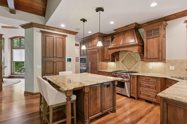 1904 Linner Rd, Minnetonka, MN 55391 - kitchen with built in appliances, custom range hood, a center island, light stone counters, and light wood finished floors