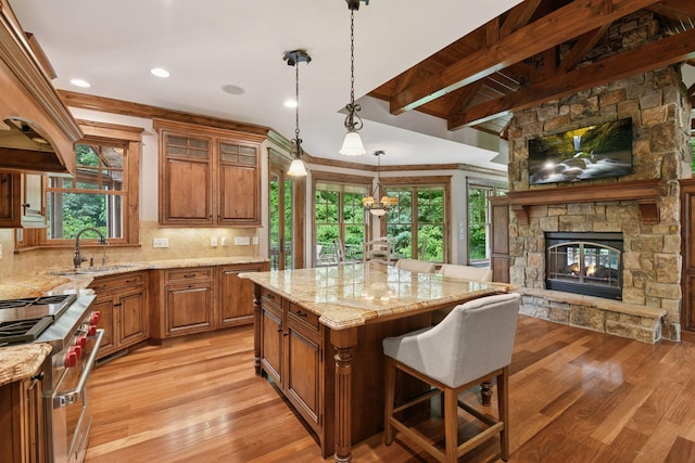 1904 Linner Rd, Minnetonka, MN 55391 - kitchen with custom range hood, brown cabinets, double oven range, light stone countertops, and beamed ceiling