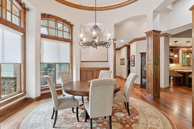 1904 Linner Rd, Minnetonka, MN 55391 - dining area featuring wood finished floors, plenty of natural light, a high ceiling, crown molding, and a chandelier
