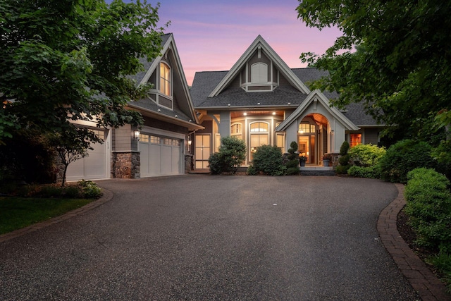 1904 Linner Rd, Minnetonka, MN 55391 - craftsman-style home with driveway, stone siding, and roof with shingles