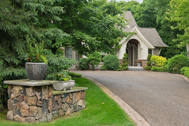 1904 Linner Rd, Minnetonka, MN 55391 - obstructed view of property with roof with shingles and stone siding