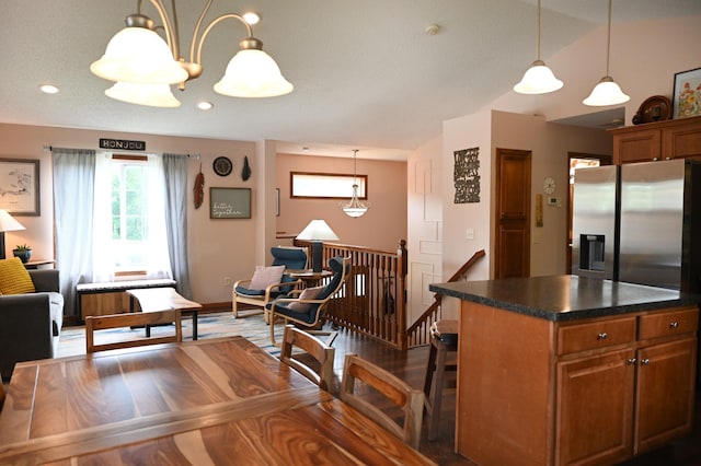 11764 35th Ave SE, Becker, MN 55308 - kitchen featuring stainless steel fridge, dark countertops, brown cabinetry, wood finished floors, and a breakfast bar